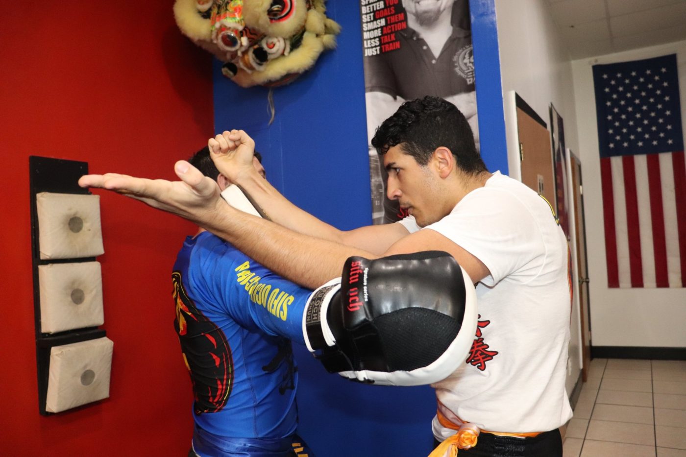 beginner wing chun student throwing defense technique towards fellow student