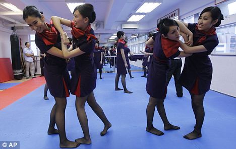 Hong Kong Airlines air stewardesses are here being shown how to give violent conduct the elbow