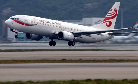Wing-ing it: A Hong Kong Airlines plane touches down at Hong Kong International airport
